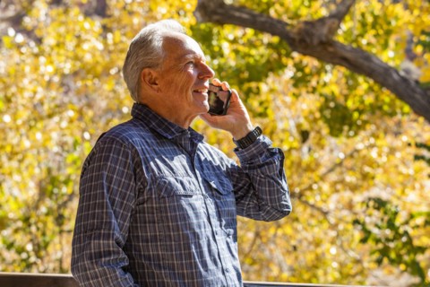 Senior man with smartphone in Zion National Park