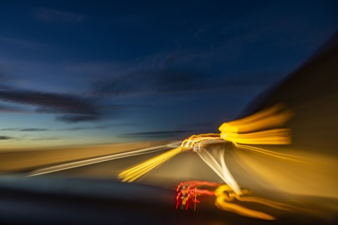 Blurred image of lights on highway at dusk