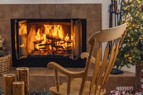 Holiday living room with fireplace and wooden rocking chair