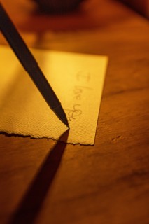 Close-up of pen writing on linen notecard