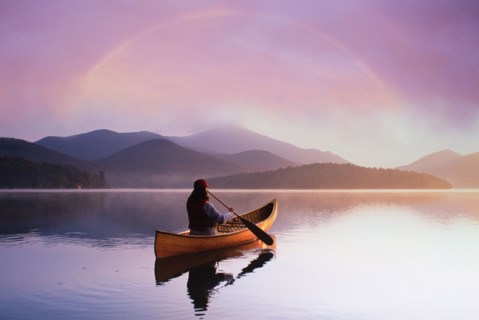 Rear view of woman canoeing