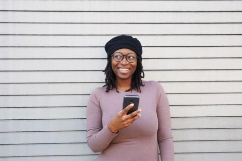 Smiling woman wearing eyeglasses and beret
