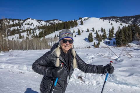 Senior female hiker hiking in mountains in winter