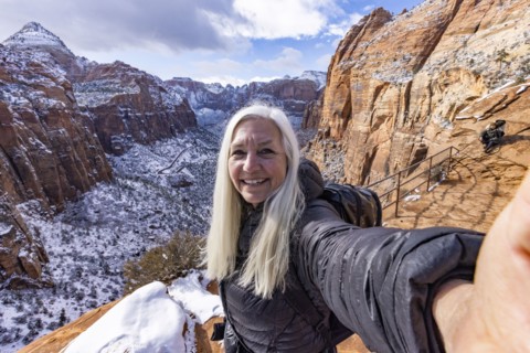Senior woman hiking in mountains in winter