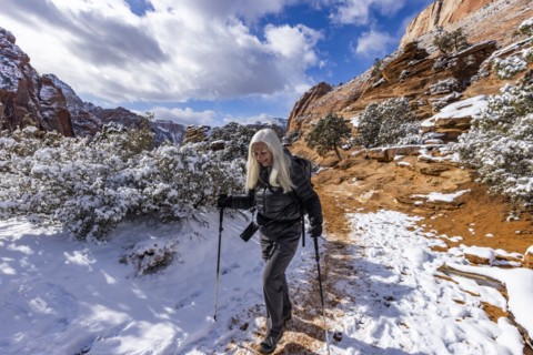 Senior woman hiking in mountains in winter