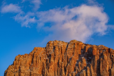 Scenic view of mountain peak against blue sky