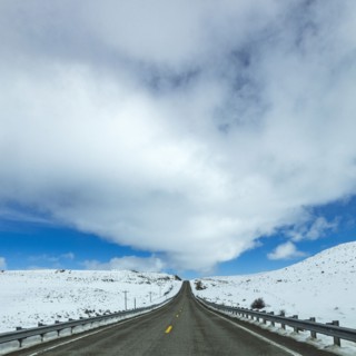 Highway through snow-covered landscape