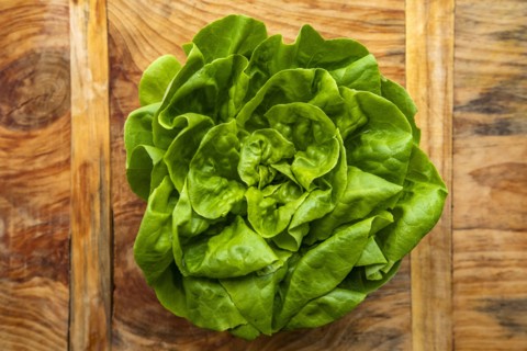 Overhead view of fresh lettuce on wooden surface