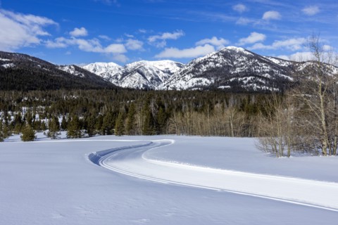 Snow-covered mountains with dirt road