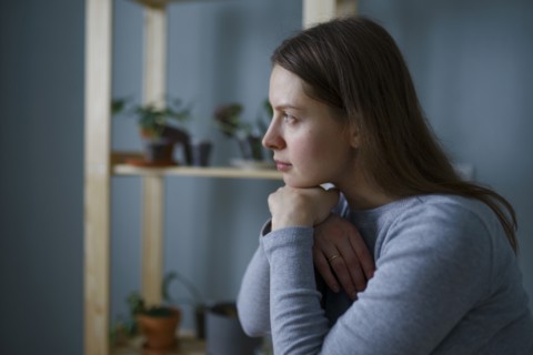 Portrait of thoughtful woman with hands on chin