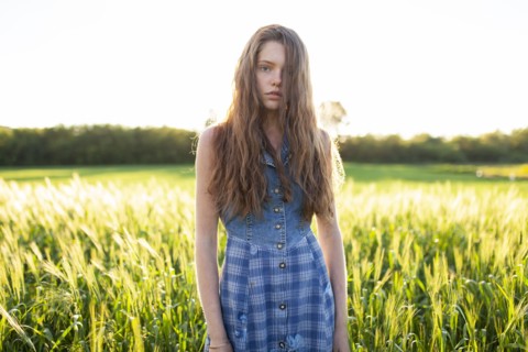 Portrait of woman standing in field