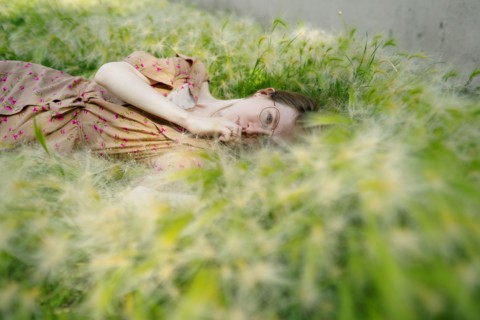 Portrait of woman lying on grass