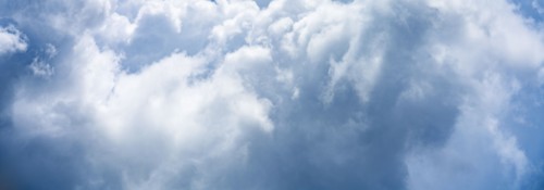 Puffy white and blue clouds on sky