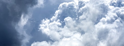 Puffy white and blue clouds on sky