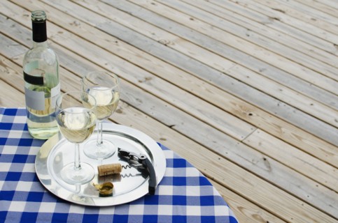 White wine bottle and glasses on table outdoors