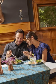 Smiling couple enjoying dinner at home
