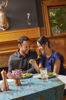 Smiling couple enjoying dinner at home