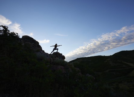 Mid adult woman doing yoga in mountains