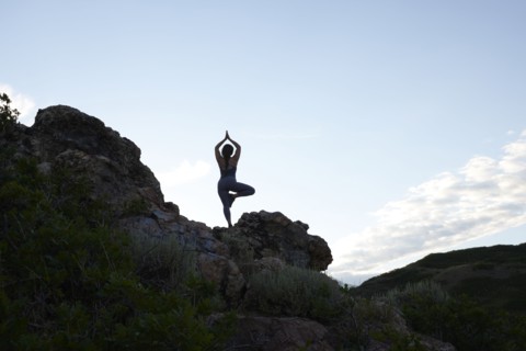 Mid adult woman doing yoga in mountains