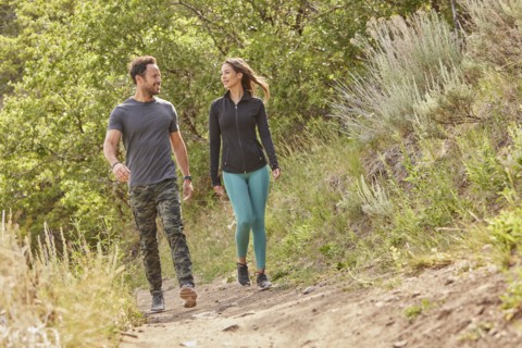 Mid adult couple hiking in forest