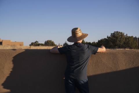 Rear view of man in hat looking at sky