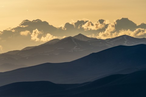 Clouds above mountains at sunset