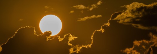 Sky with clouds and setting sun