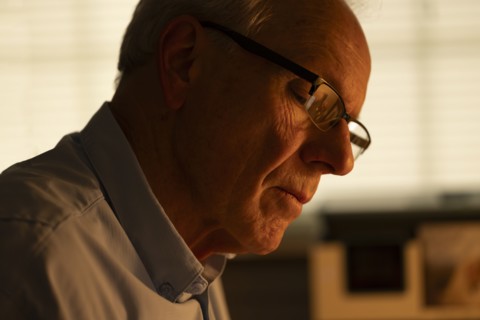 Portrait of thoughtful senior man looking down at home