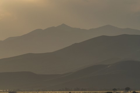 Mountain landscape in fog at sunset
