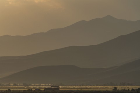 Mountain landscape in fog at sunset