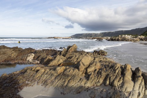 Distant view of boy bodyboarding