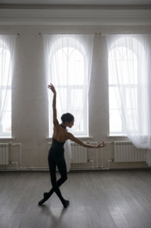 Back view of ballerina dancing at studio
