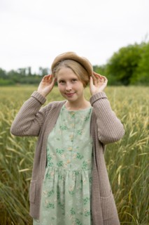 Portrait of young woman wearing beret standing in wheat field