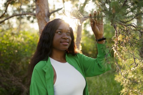 Woman touching twig and looking at it