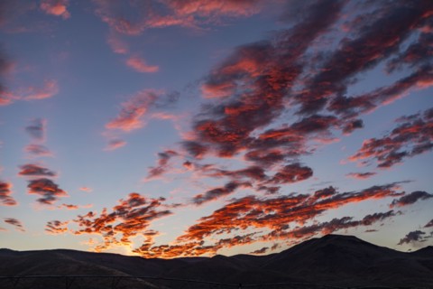 Silhouette of mountains with sunrise in background