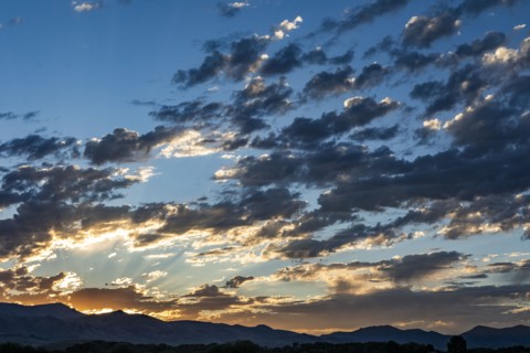 Silhouettes of mountains with sunrise in background