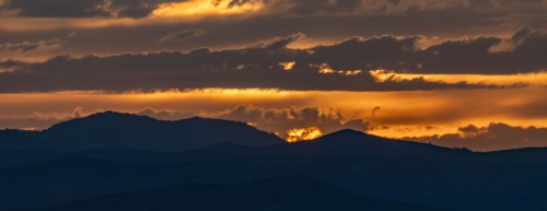 Beautiful sunset over silhouettes of mountains