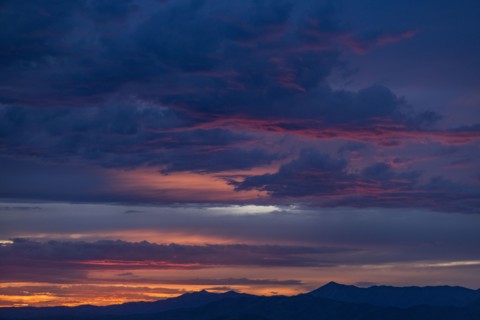 Beautiful sunset over silhouettes of mountains