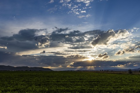 Cloudy sunset sky over rural landscape
