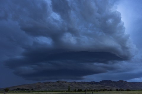 Arcus cumulonimbus storm clouds rolling across farmland