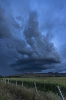Arcus cumulonimbus storm clouds rolling across farmland