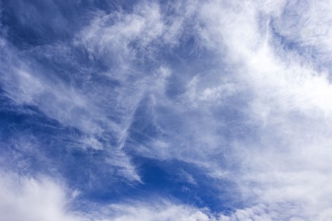 Wispy white clouds in blue sky