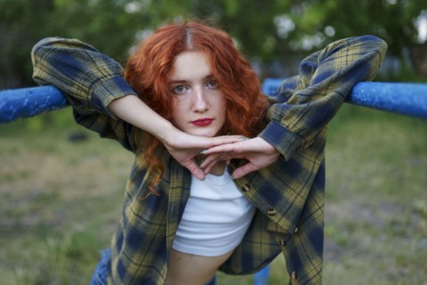 Redhaired woman posing at playground