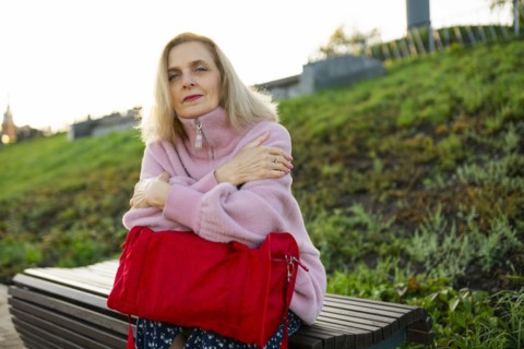 Portrait of serious woman sitting on bench