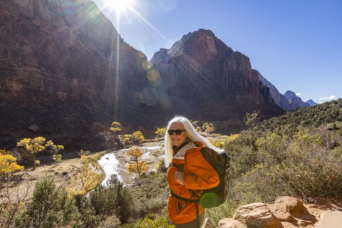 Portrait of woman hiking near Angels Landing Trail overlooking Virgin River, , Utah, USA
