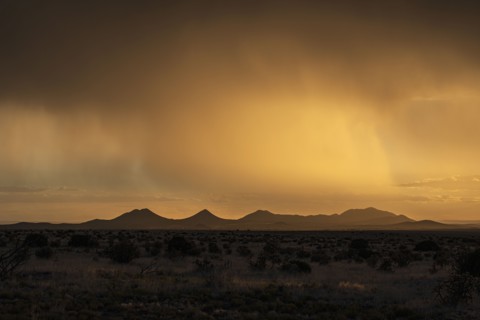 Usa, New Mexico, Santa Fe, Storm and rain over Cerrillos Hills at sunset, Santa Fe, New Mexico, USA