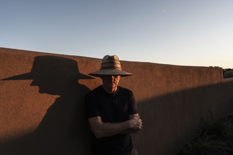 Usa, New Mexico, Santa Fe, Portrait of man in straw hat against adobe wall, Santa Fe, New Mexico,