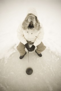 USA, NY, Hammond, High angle view of man ice fishing on frozen Black Lake, Hammond, Hammond, New