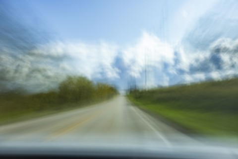 USA, Wisconsin, Country road and clouds seen from moving car, Mt. Horeb, Wisconsin, USA