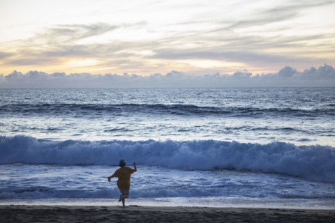 Mexico, Baja, Pescadero, Silhouette of boy on beach at dusk, Pescadero, Baja, Mexcio